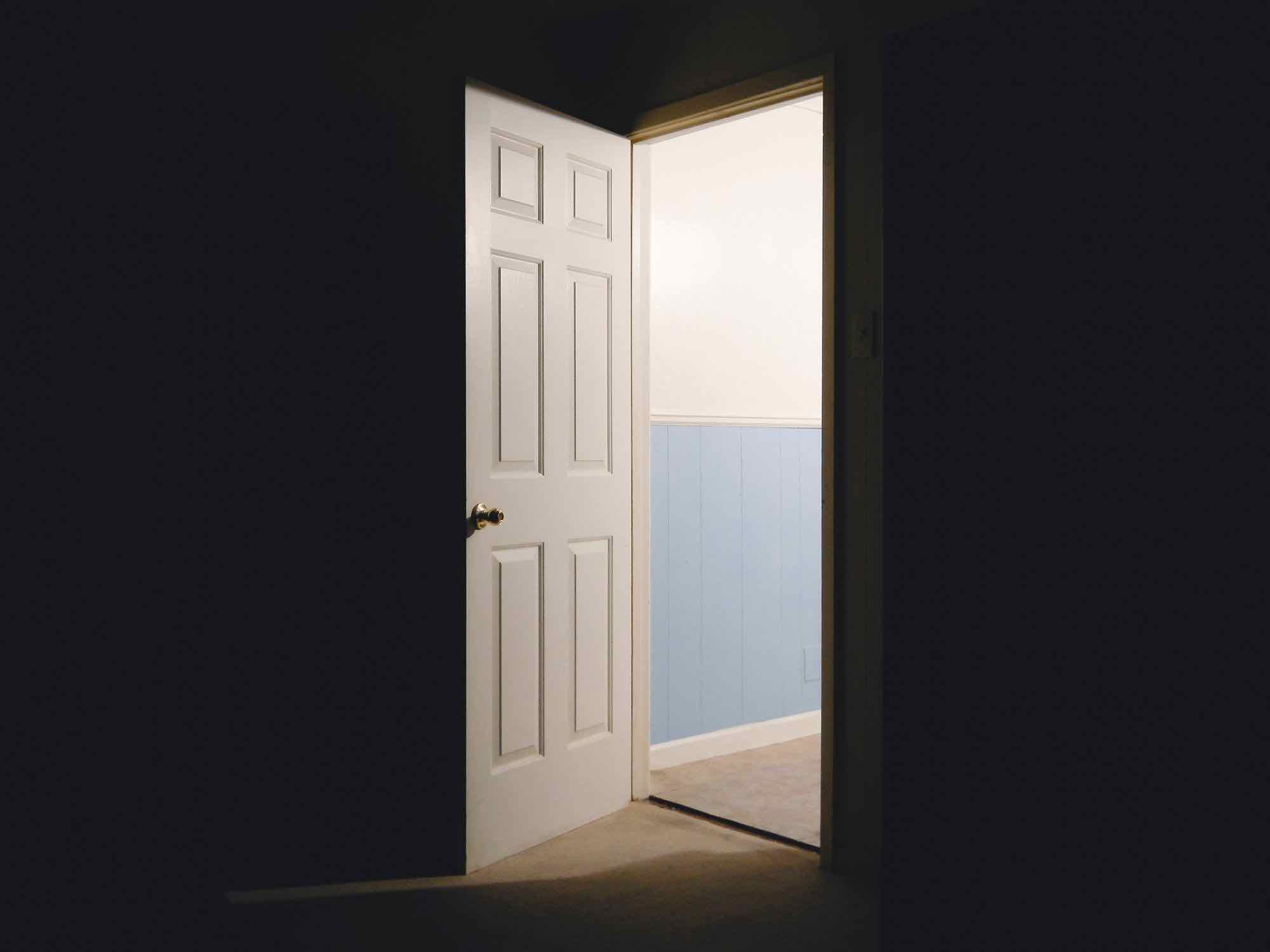 Photo of a door opening into a dark room