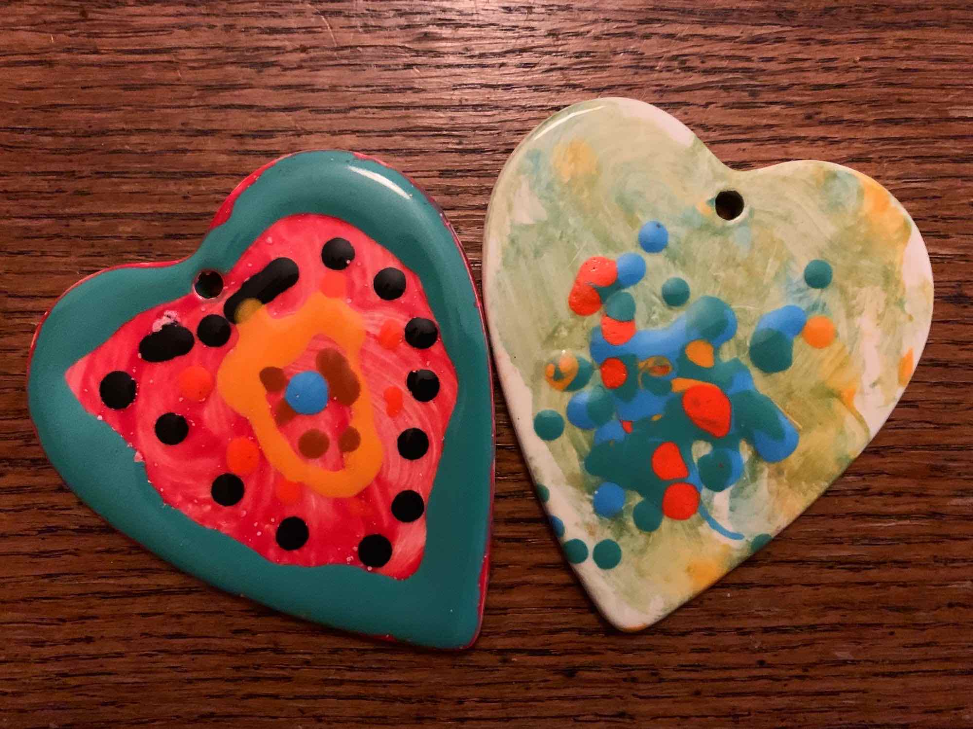 Photo of two colourful ceramic heart decorations